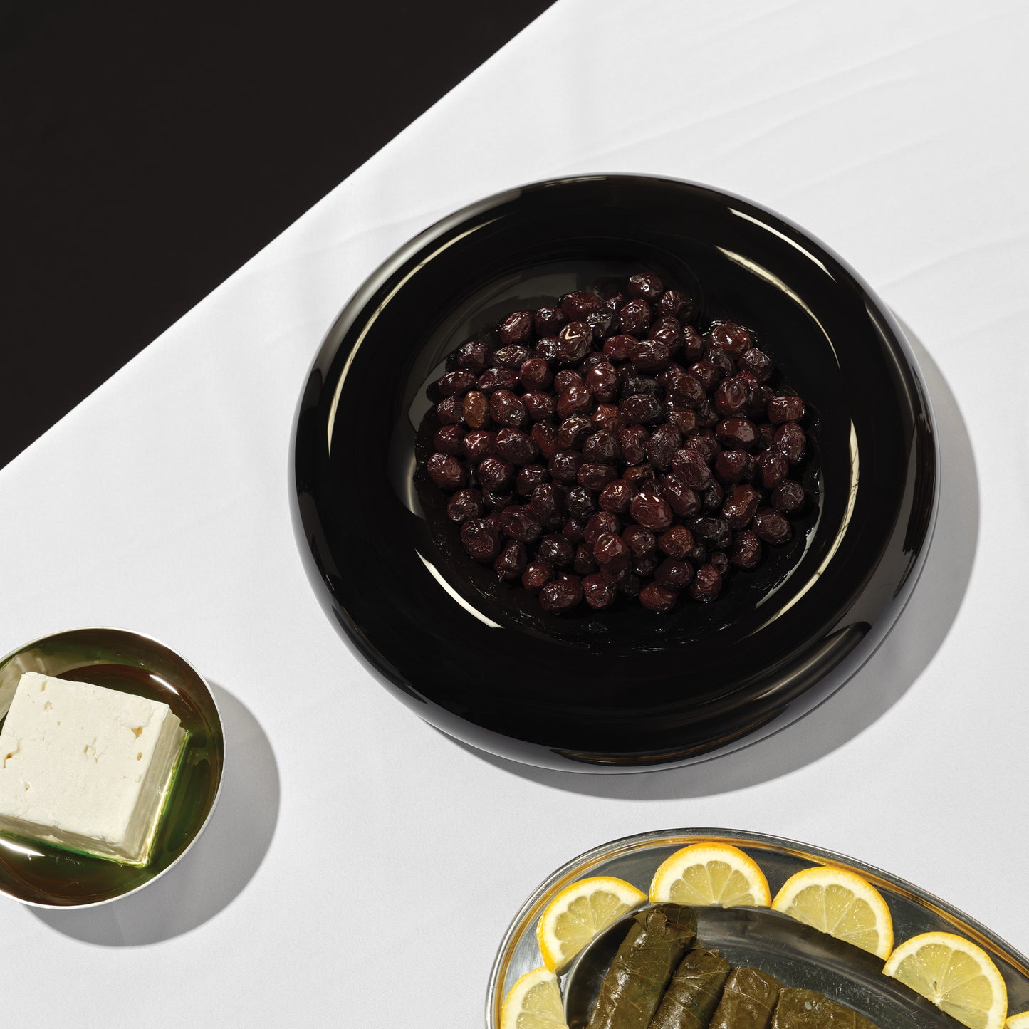 Large Syrup bowl on a table with olives in liquorice colour